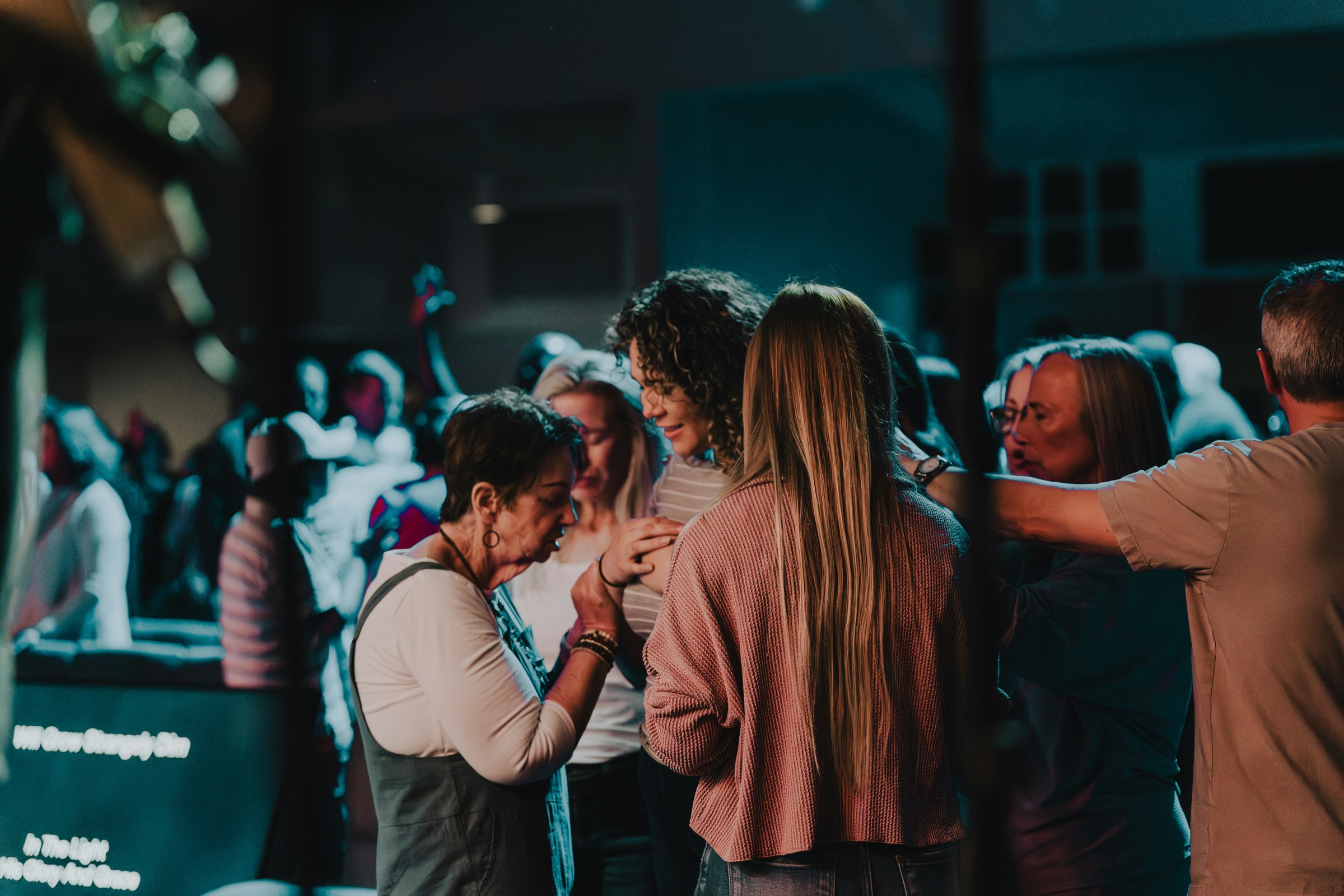 People praying together during a worship service at Westwood Church